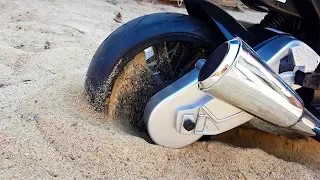 The power wheels sport bike stuck in the sand