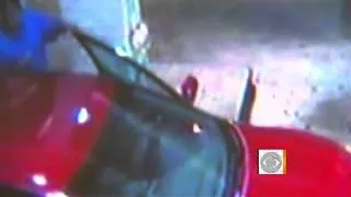Man clings to hood of car, caught on tape
