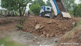 Dump Truck Working Pour The Soil Into The Mud Pit - Mini Bulldozer Push The Ground To Remove The Mud