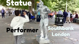 Statue street performer Southbank London, See human statue performer move, silver living statue