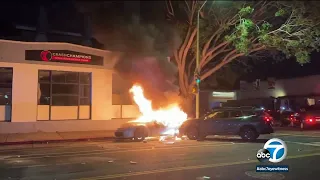 Car goes up in flames while dozens of other cars back up traffic after Oakland street takeover