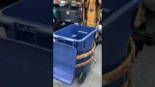 Garbage truck eats recycle can