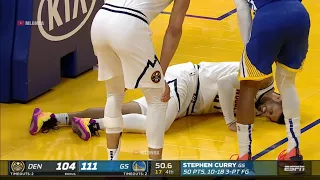 Jamal Murray is down in serious pain and is clutching his knee