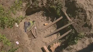 Shallow tunnel found at homeless camp along I-405