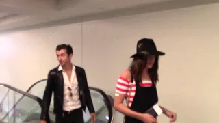 Alex Turner and Arielle Vandenberg talk about One Direction as they depart at LAX Airport