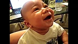 4 month old baby laughing hysterically at a trash bag