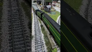 Unrebuilt Merchant Navy class locomotive in Malachite green passing over streamlined points.