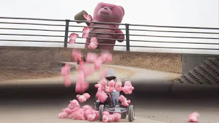 She has no idea that a pink teddy bear will fall from the sky. Giant pink bear prank.
