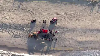 Sand collapses onto teens digging hole at beach at Jersey Shore