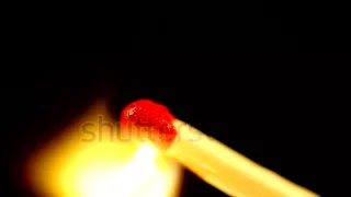 Match lighting and burning in slow motion extreme macro shot on black background