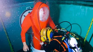 Divers Pulling Out Man From Submarine During Rescue Operation