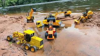 Retirando areia do rio com veículos de construção