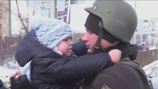 Ukrainian soldier says goodbye to child before going off to war