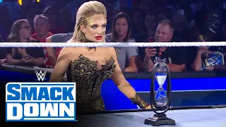 Scarlett places an hourglass in front of Roman Reigns