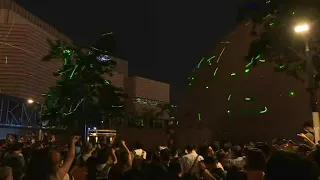 Hong Kong crowds protest student arrest with laser light show | AFP