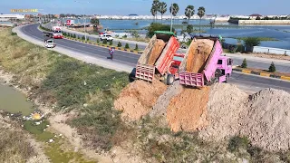 Operator KOMATS'U  Dozer D-31-P Pushing  Soil with Dump Trucks 5 tons Next to Highway