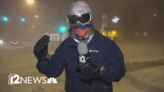 High winds whip around reporter as snow falls in Flagstaff