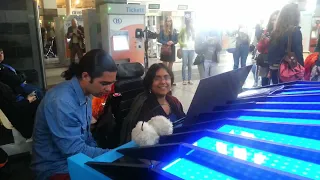 Public piano tango duet improvisations in a park and a train station