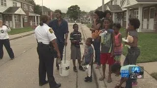 Portsmouth police officers walk through neighborhood of latest homicide