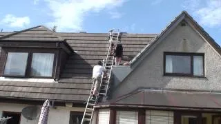 Josh climbing to the top of the roof