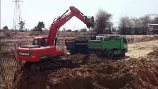 Excavator Doosan loading on truck