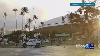 WATCH: Light pole falls just missing cars driving through