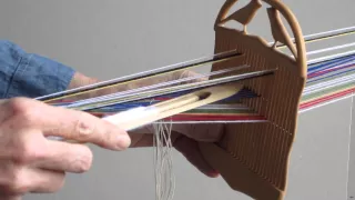 Weaving narrow bands with a double holed heddle