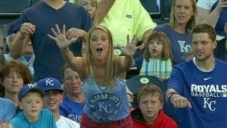 Kid snags souvenir from lady at the ballgame
