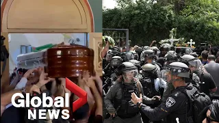 Israeli police charge at mourners carrying Al Jazeera journalist's coffin at funeral in Jerusalem