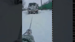 Suzuki Vitara on snow pull a sled