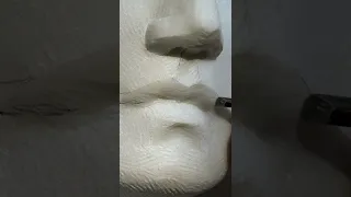 Carving a mouth in marble