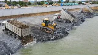 Good Team! Skill Operator Bulldozer Clearing Stone Into the Deep Water with Truck unloading Stone