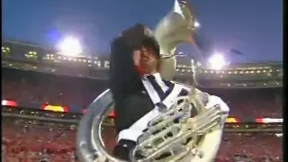 Tuba player hits camera man with tuba