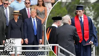 Towering Barron Trump walks at high school graduation as proud parents Donald and Melania look on