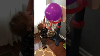 Toddler basketball hoop dunk with ball that is way too big