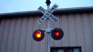 Old railroad crossing signal with rare bell outside a hobby shop (WRRS Mini-Bell)