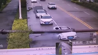 large pole falling on a car