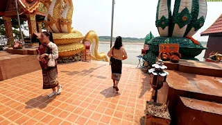 Lao temple by Mekong river. Feeding the fish @ Wat Tong Tad