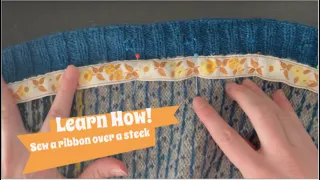 Learn with Yarnia ~~ Sewing a ribbon over a steek with fell stitch