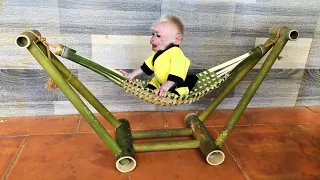 Baby monkey Bon really likes the bamboo hammock father made