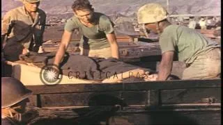 Wounded Marines are loaded into a DUKW in Iwo Jima, Japan during World War II. HD Stock Footage