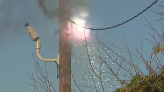 Sparking power line adds to danger for crews battling house fire