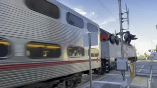 Loud horns and full speed Caltrain passing near San Mateo station