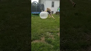 Oscar plays outside with a wubble bubble.