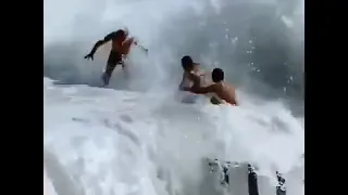 A couple of lovers dragged by the waves while on the beach