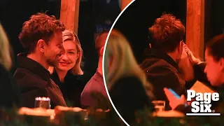 Gigi Hadid plants a kiss on Bradley Cooper during PDA-packed date night in NYC