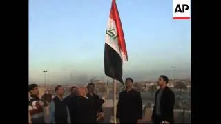 New Iraq flag stripped of Baath Party symbols is hoisted