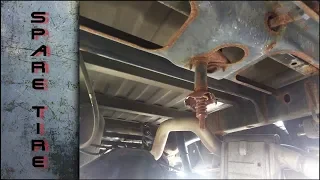 Removing a stuck spare tire from below the vehicle