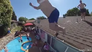 Guy Trying to Jump off Roof into Pool Slips and Falls to Ground - 1055385