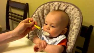 Cute baby eating rice cereal.